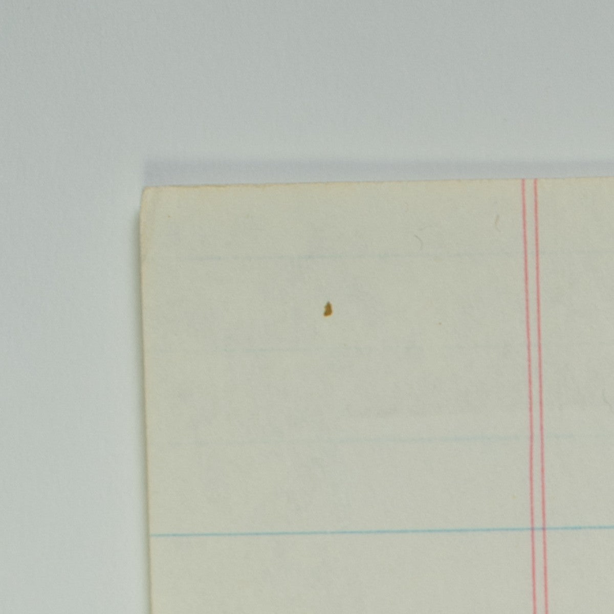 Detail of “Flare for the Dramatic”: an ink dot near the corner of the sheet